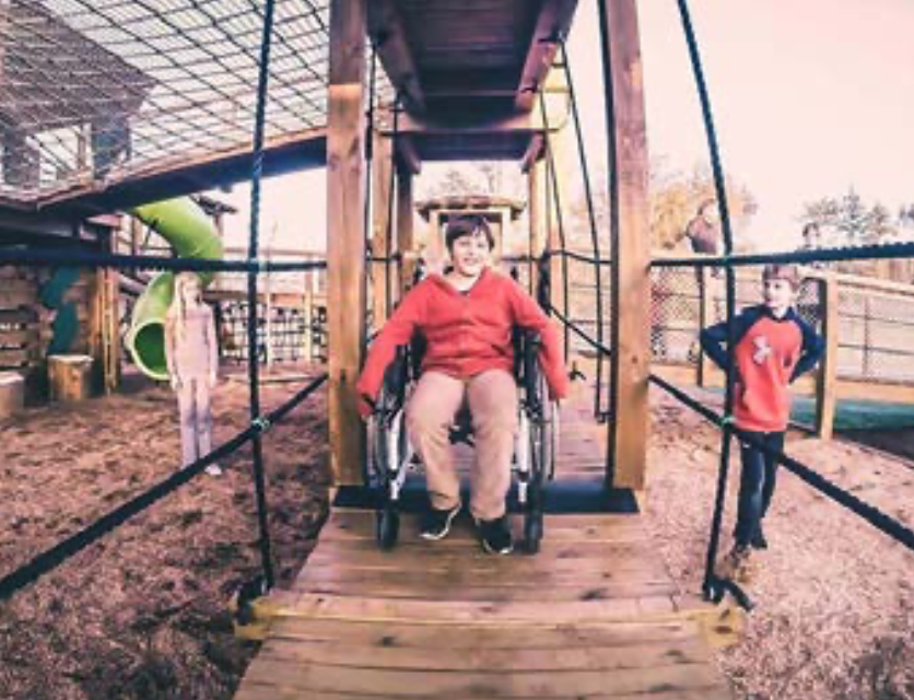 child in wheelchair doing rope course
