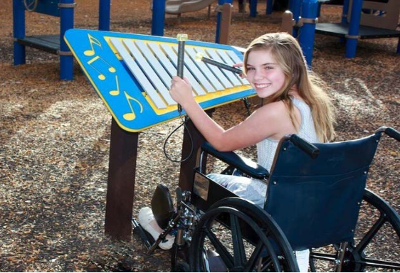 girl in wheelchair playing